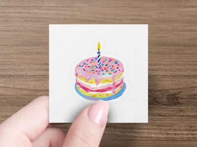 Birthday cake with pink frosting, sprinkles, and one candle on a white card.