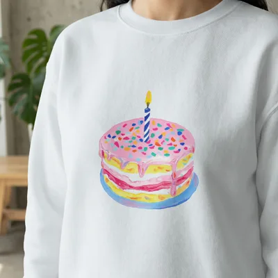 Watercolor birthday cake with pink frosting and a lit candle.