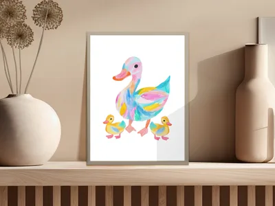 Colorful duck and two ducklings illustration in a frame on a shelf.