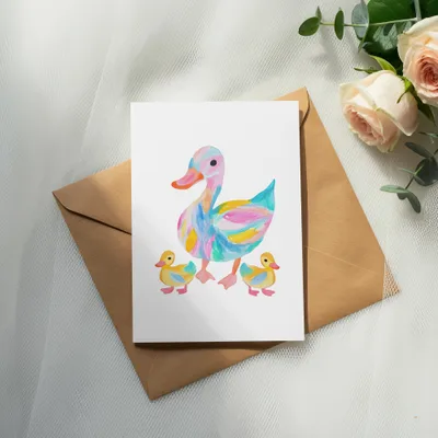 Watercolor painting of a colorful duck and two ducklings on a card.