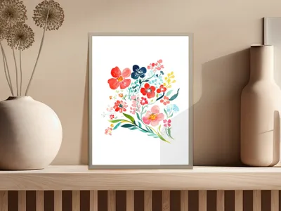 Colorful watercolor floral bouquet in a framed print on a shelf.