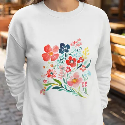 White sweatshirt with a watercolor floral bouquet in red, blue, and yellow.