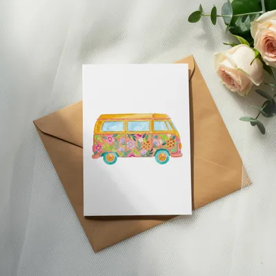 Watercolor camper van with floral pattern on white card.