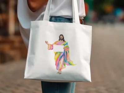 Jesus in colorful robes holds a blank sign on a white tote bag.