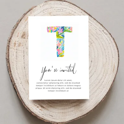 Invitation card with a floral "T" and "You're invited" text.