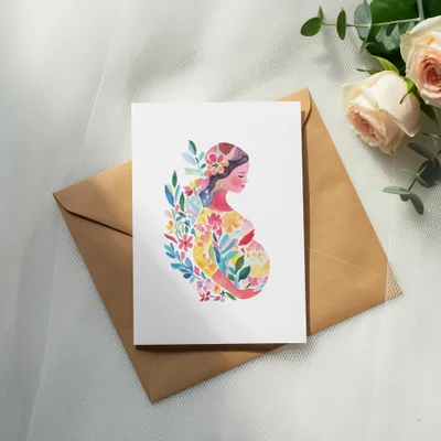 Watercolor illustration of a pregnant woman surrounded by colorful flowers on a card.