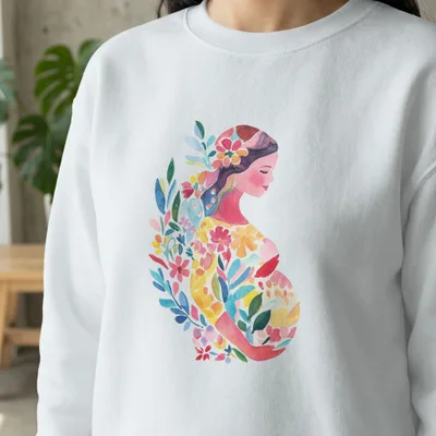 Watercolor illustration of a pregnant woman with floral and leaf design on sweatshirt.