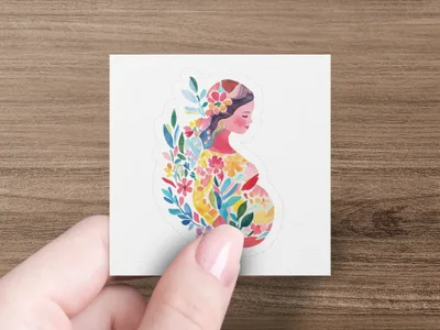 Pregnant woman with colorful floral embellishments on a white sticker.