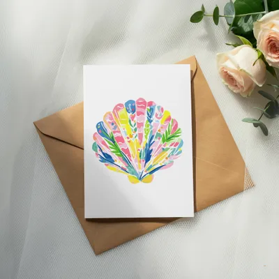 Greeting card with a colorful seashell illustration on an envelope.