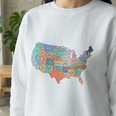 White sweatshirt with a colorful, patterned map of the United States.