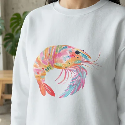 Watercolor shrimp illustration on a white sweatshirt.