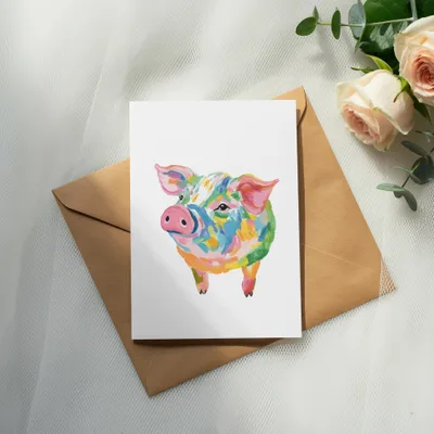 Card with watercolor pig illustration on a brown envelope with roses.