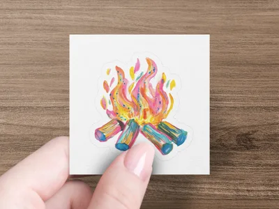Campfire sticker with colorful flames and logs held by fingers.