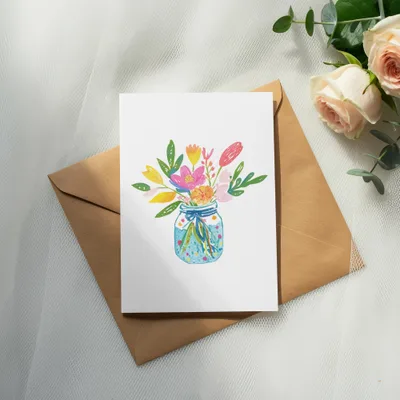 Watercolor illustration of a mason jar filled with colorful flowers on a white card.