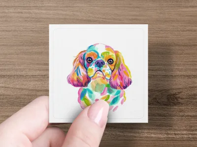 Watercolor portrait of a Cavalier King Charles Spaniel's face in vibrant colors.