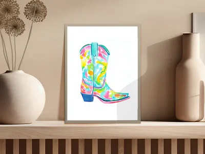 Colorful abstract watercolor cowboy boot art print in a white frame.