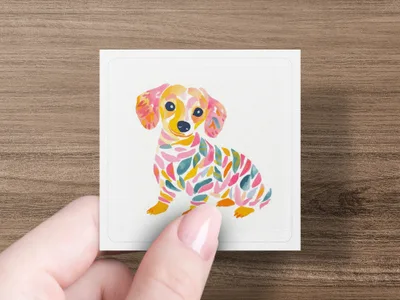 Colorful abstract watercolor dachshund puppy illustration on white card.