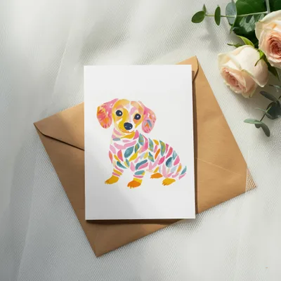 Card with colorful dachshund illustration on a brown envelope.