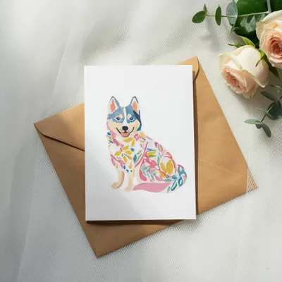 Card with a colorful floral dog illustration on a kraft envelope.
