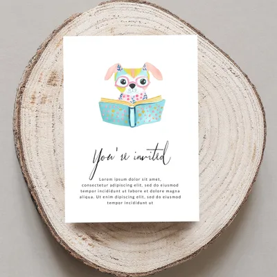 Invitation card with watercolor dog reading book, "You're invited" text.