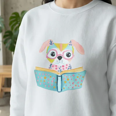 White sweatshirt with watercolor illustration of a dog wearing glasses reading a book.