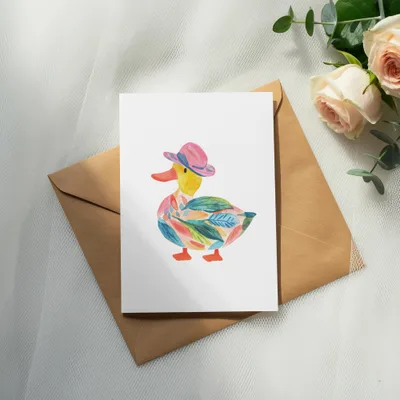 Watercolor duck wearing a pink hat on a card.