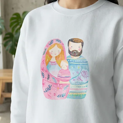 Matryoshka doll style illustration of a family with a baby on a white sweatshirt.