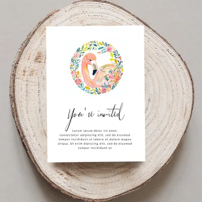 Invitation card with flamingo wreath and placeholder text.