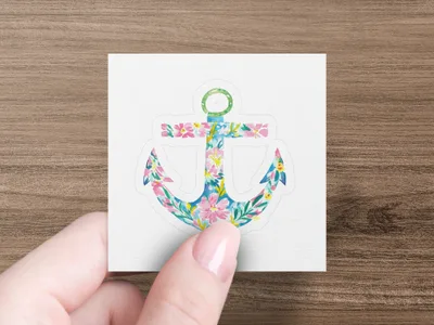 Anchor sticker with floral pattern held by hand.