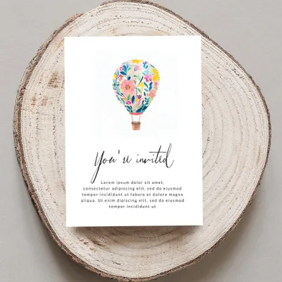 Invitation with hot air balloon illustration and "You're invited" text.