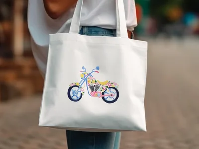 White tote bag with a colorful floral motorcycle design.