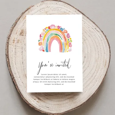 Invitation with watercolor rainbow and floral art, "You're invited" text.