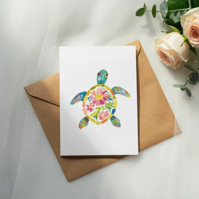 Card with colorful floral turtle illustration on brown envelope.