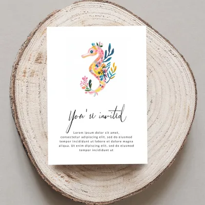 Invitation card with watercolor seahorse and floral border, text reads "You're invited".