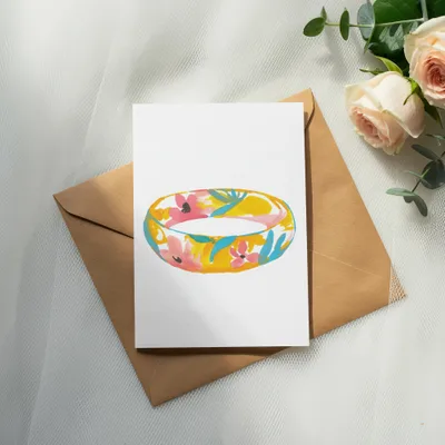 Card with floral ring illustration on brown envelope with roses.