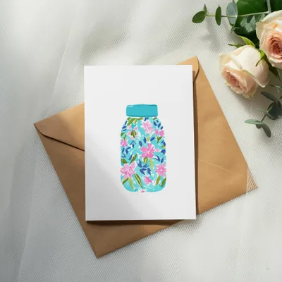 Card with a blue mason jar design featuring pink and blue flowers.