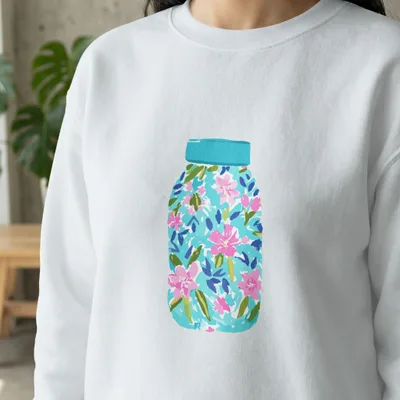 White sweatshirt with a colorful floral mason jar design.
