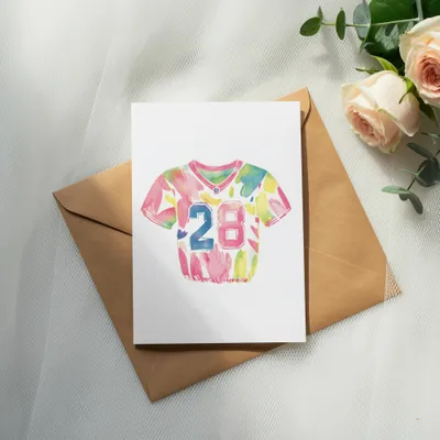 Watercolor football jersey with number 28 on card over envelope.