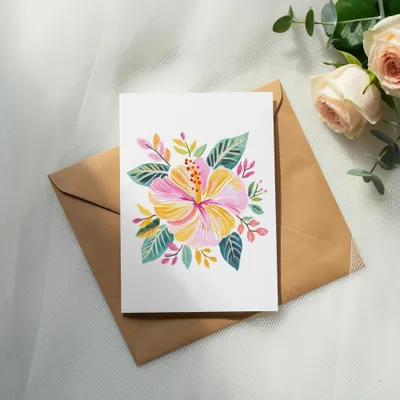 Floral watercolor card on kraft envelope with roses and eucalyptus.