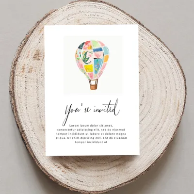Invitation with hot air balloon illustration and "You're invited" text.