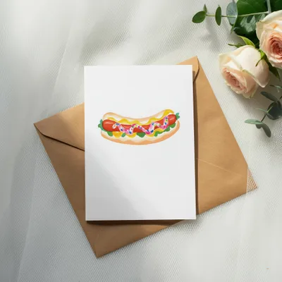 Illustration of a hot dog on a white card with envelope and roses.