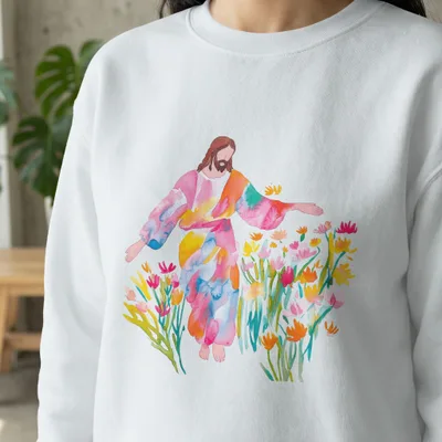 Jesus wearing a colorful robe in a field of flowers.