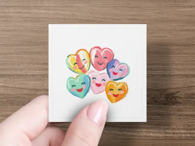 Bunch of colorful candy hearts with smiling faces.