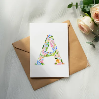 Card with a large letter A in floral pattern on an envelope.