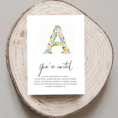 Invitation card with large floral letter "A" and "You're invited" text.