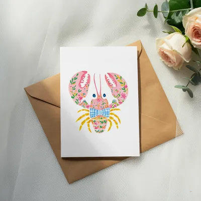 Pink lobster illustration with floral accents and blue bow tie on a card.