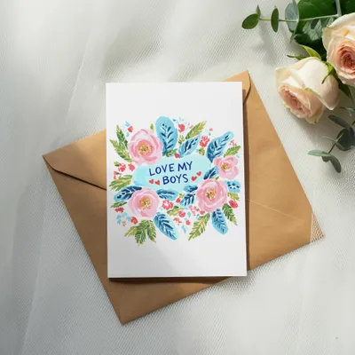 Card with "Love My Boys" text surrounded by watercolor flowers on envelope.