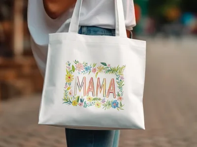 White tote bag with "MAMA" in colorful floral watercolor wreath.