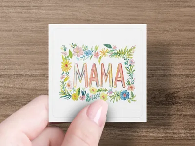 Mama text with floral border, held by hand.