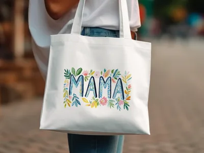 White tote bag with floral "MAMA" lettering.